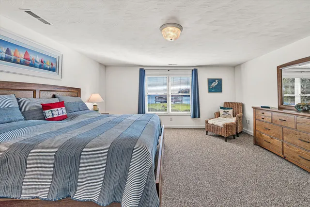 a view of a swimming pool with outdoor seating and lake view