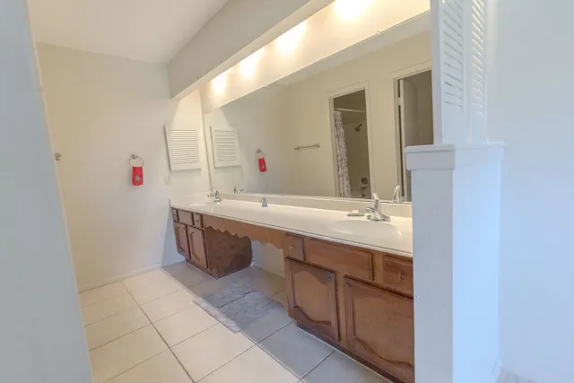 an empty room with a window and a ceiling fan