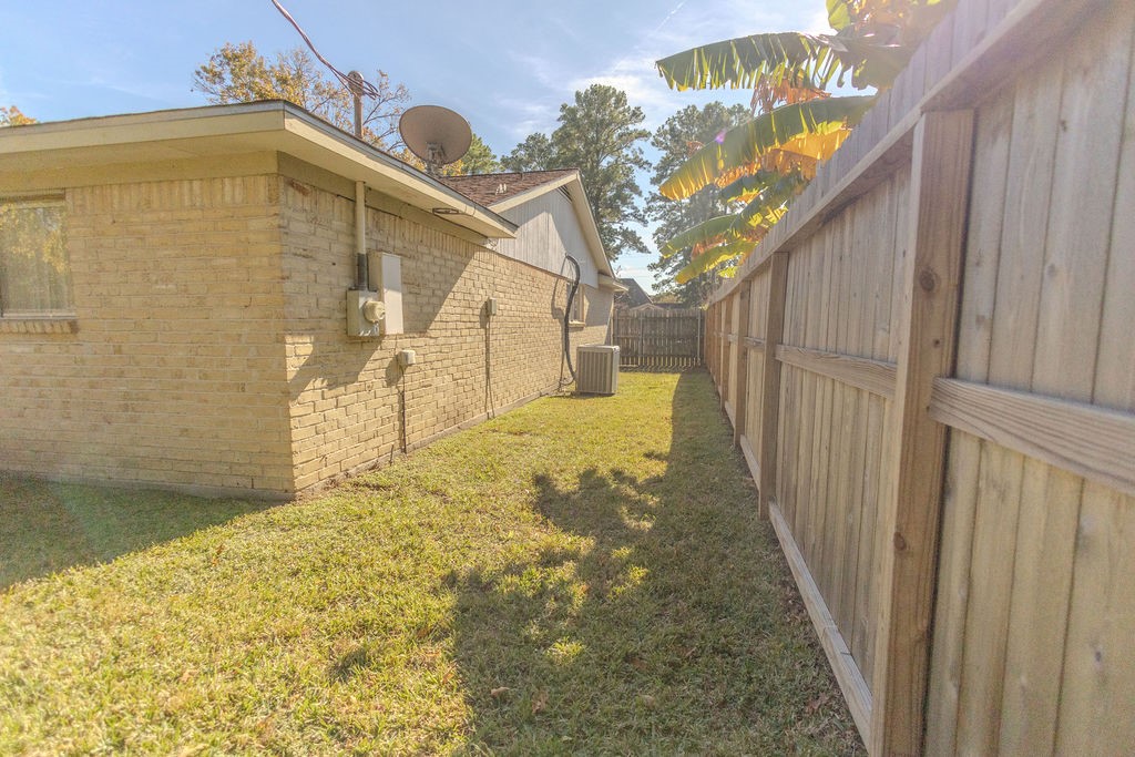 9806 Cane Creek Drive Houston, TX 77070 - Photo 18 of 28 a yellow house with trees in front of it