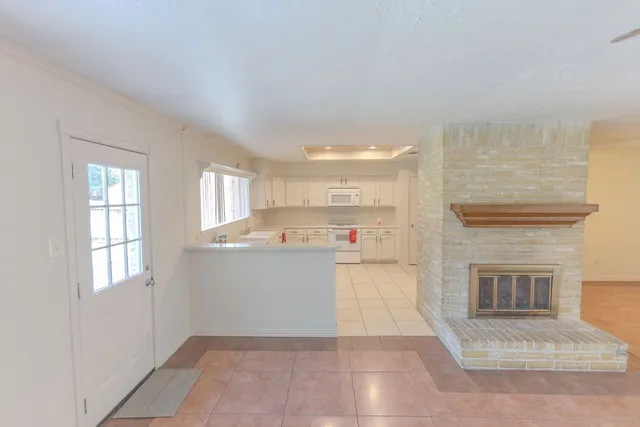 a utility room with cabinets washer and dryer