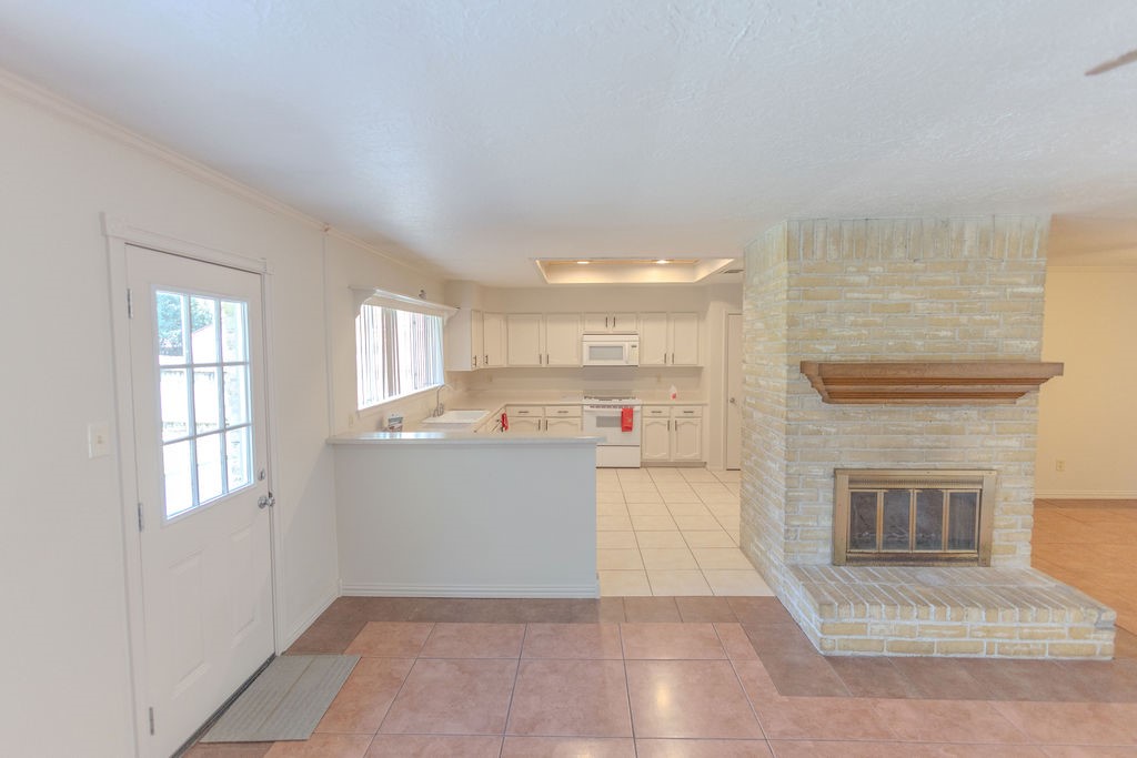 9806 Cane Creek Drive Houston, TX 77070 - Photo 21 of 28 a living room with furniture and a fireplace