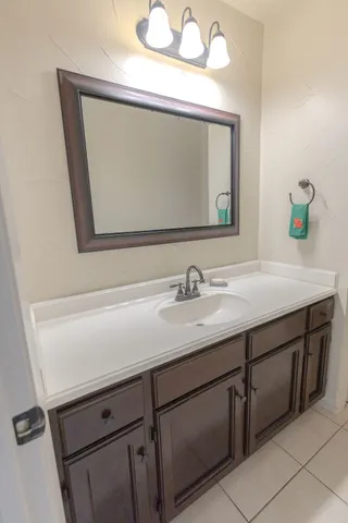 a bathroom with a double vanity sink a mirror and a bathtub