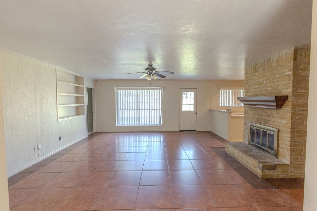 9806 Cane Creek Drive Houston, TX 77070 - Photo 4 of 28 an empty room with windows and fireplace
