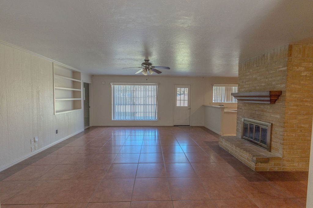 9806 Cane Creek Drive Houston, TX 77070 - Photo 5 of 28 a view of an empty room with a fireplace and windows