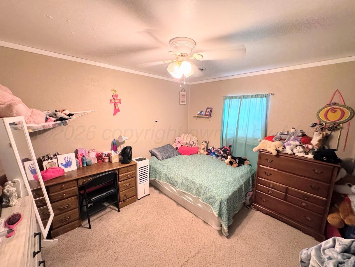 1413 South Harvard Street Perryton, TX 79070 - Photo 6 of 14 a bedroom with furniture and a bed