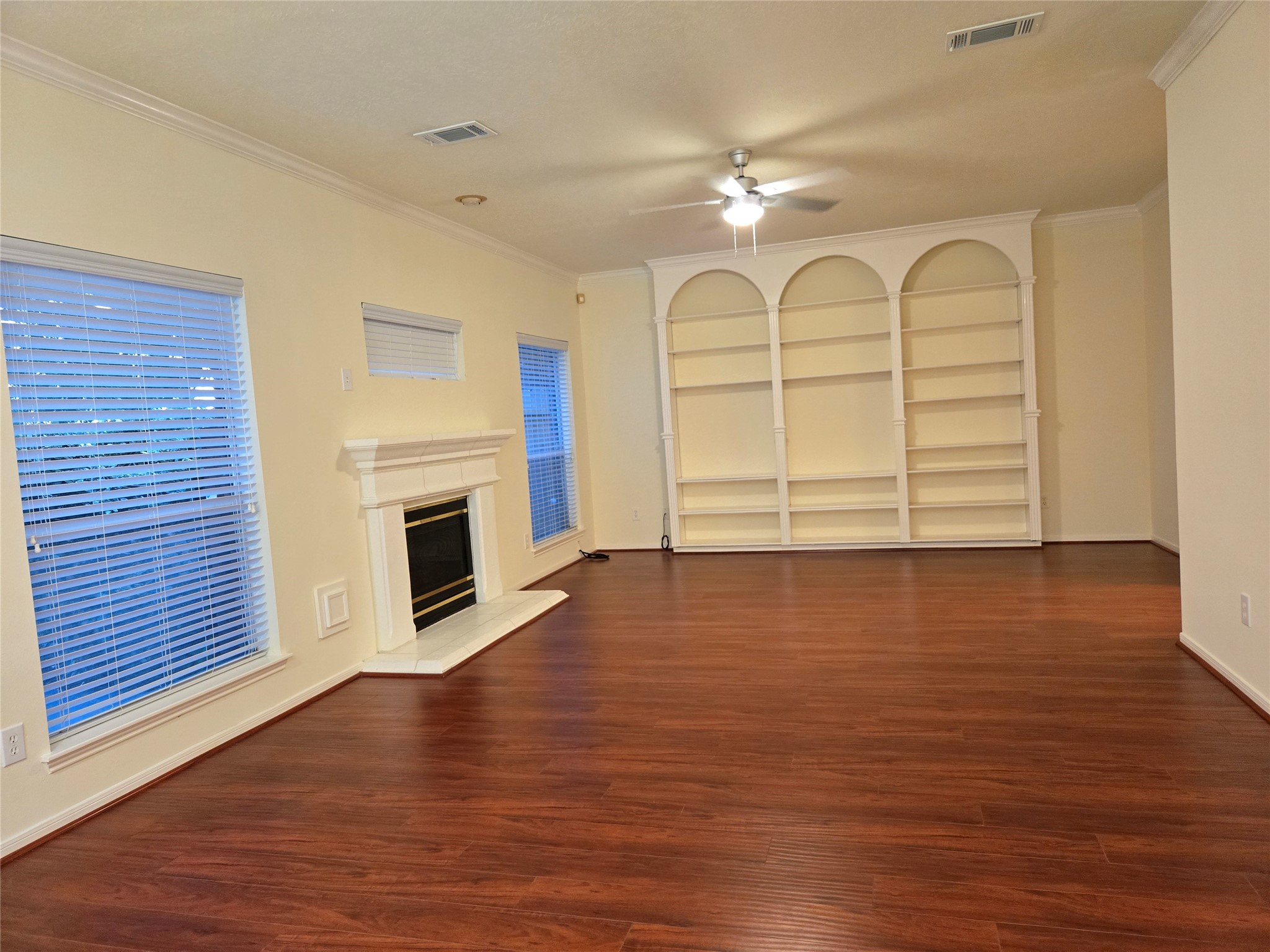 3138 Waters Way Drive Sugar Land, TX 77478 - Photo 11 of 42 a view of a livingroom with wooden floor a fireplace and window