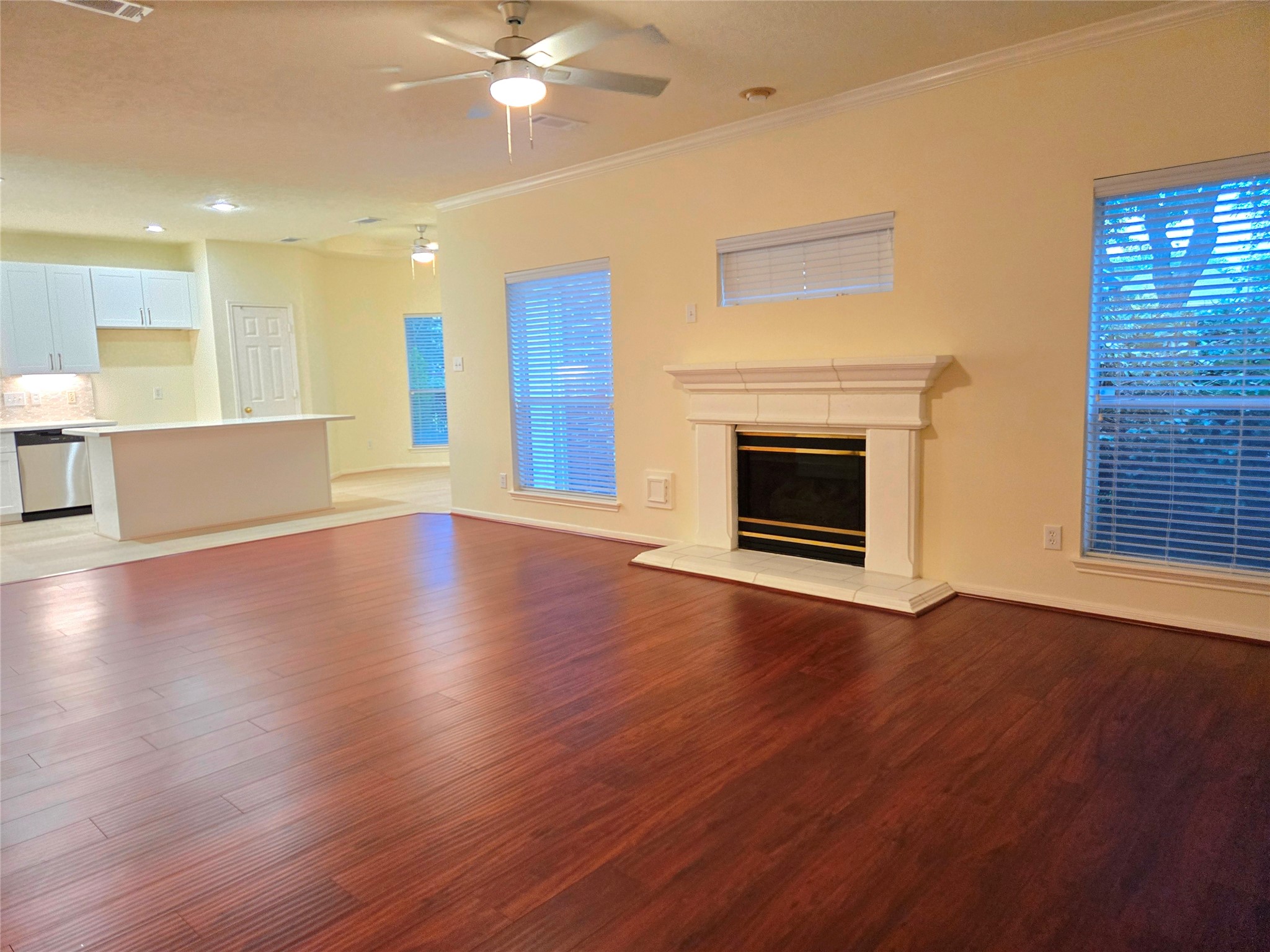 3138 Waters Way Drive Sugar Land, TX 77478 - Photo 13 of 42 an empty room with wooden floor fireplace and windows