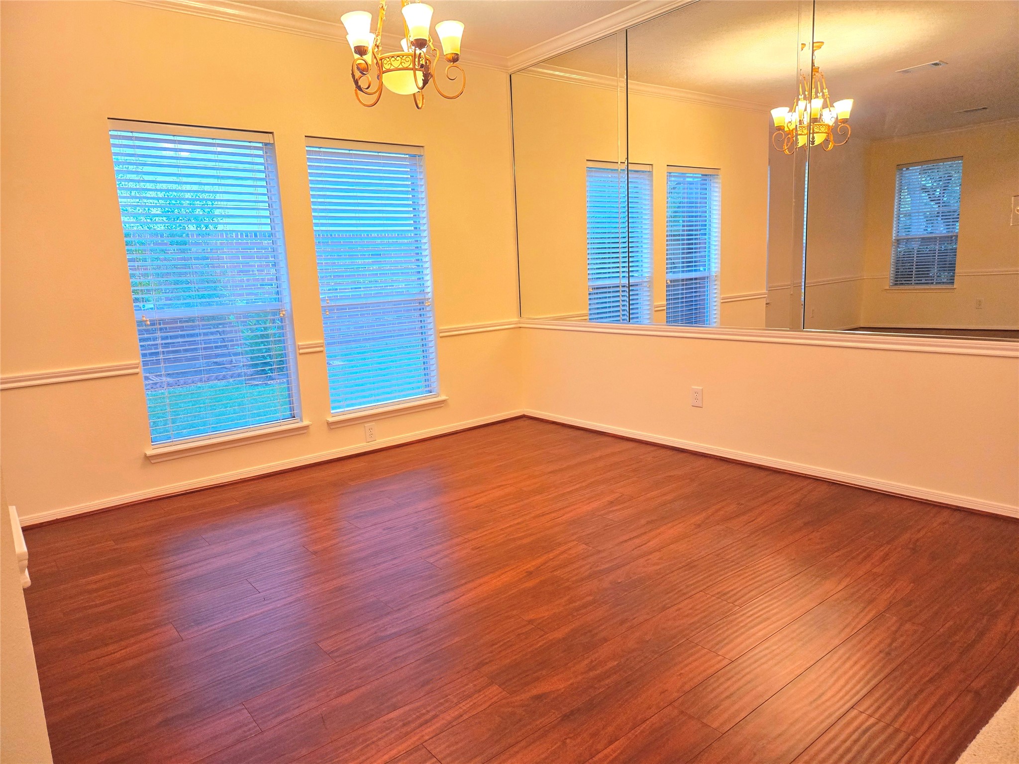 3138 Waters Way Drive Sugar Land, TX 77478 - Photo 15 of 42 a view of a room with wooden floor and chandelier