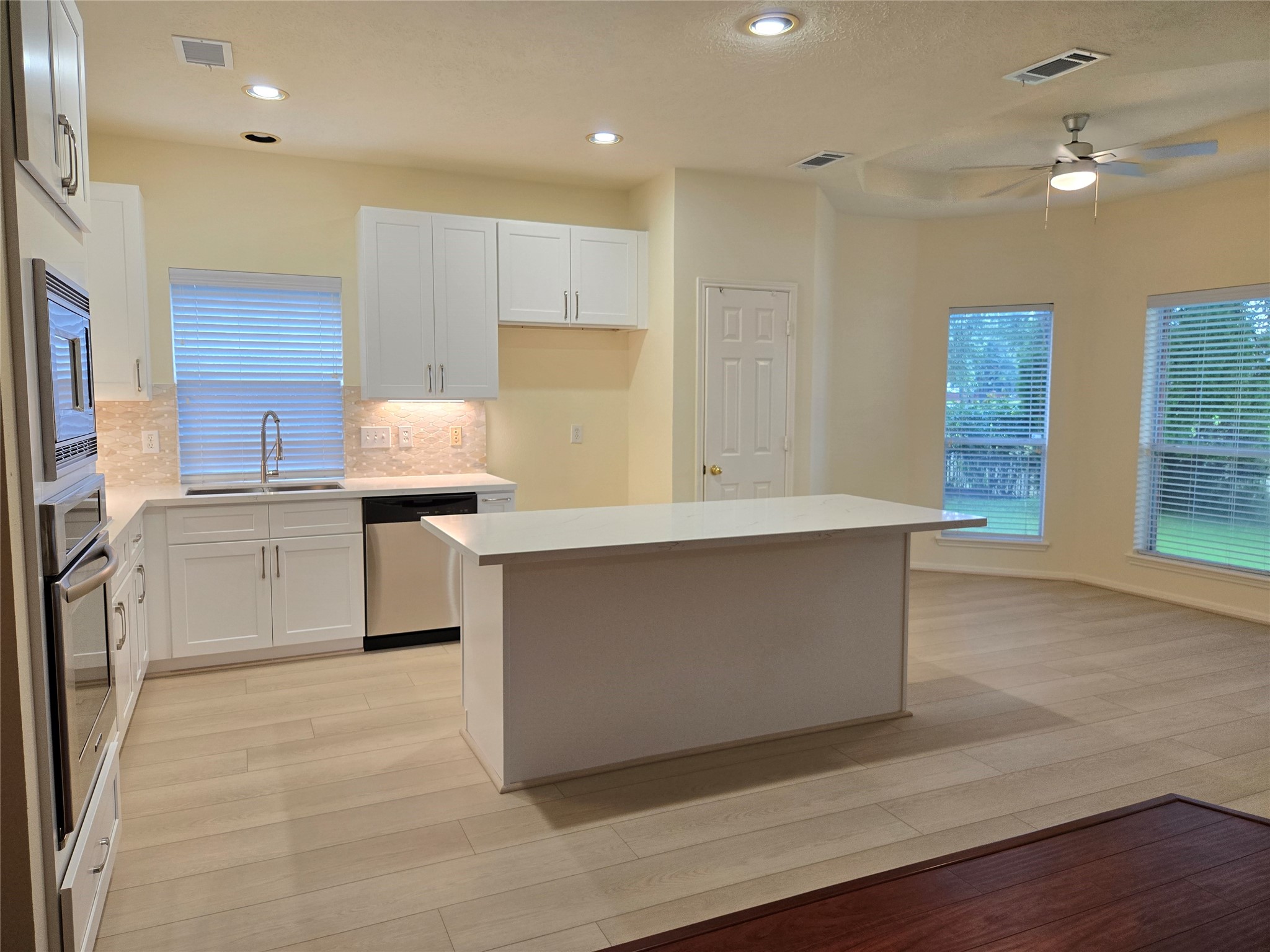 3138 Waters Way Drive Sugar Land, TX 77478 - Photo 16 of 42 a kitchen with stainless steel appliances a sink a stove a refrigerator and cabinets