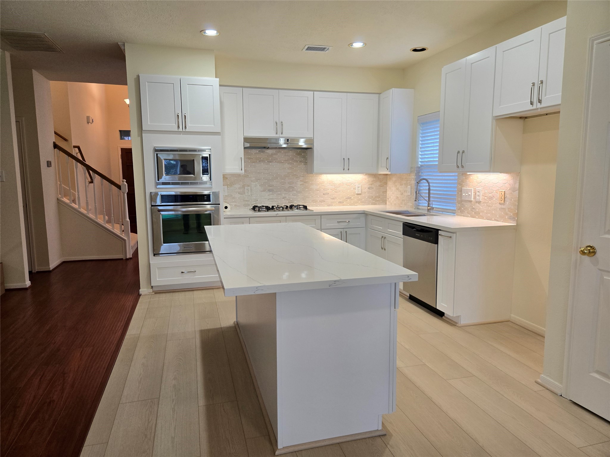 3138 Waters Way Drive Sugar Land, TX 77478 - Photo 20 of 42 a kitchen with stainless steel appliances a stove refrigerator sink and cabinets