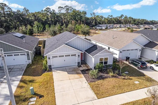 a large kitchen with stainless steel appliances granite countertop a sink a stove and a refrigerator