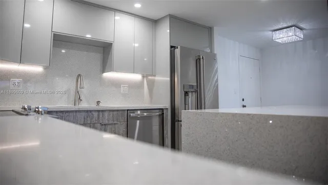 a kitchen with stainless steel appliances a refrigerator and a sink