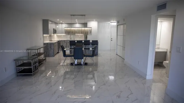 a room with lots of table chair and glass door