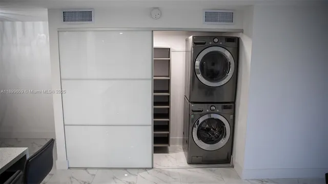 a utility room with sink dryer and washer