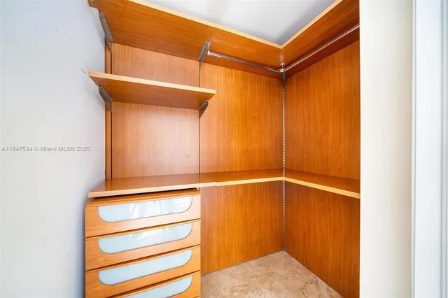 a view of a room with a door and a ceiling fan