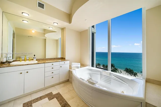 a bathroom with a large tub sink and vanity
