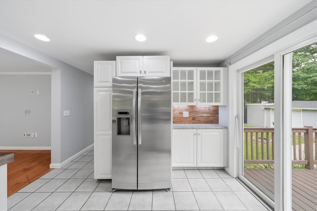 214 Anan Wade Road Glocester, RI 02857 - Photo 16 of 50 A sliding glass door provides direct access to the oversized entertainment deck, creating an effortless transition from indoor living to outdoor dining, grilling, and gatherings.