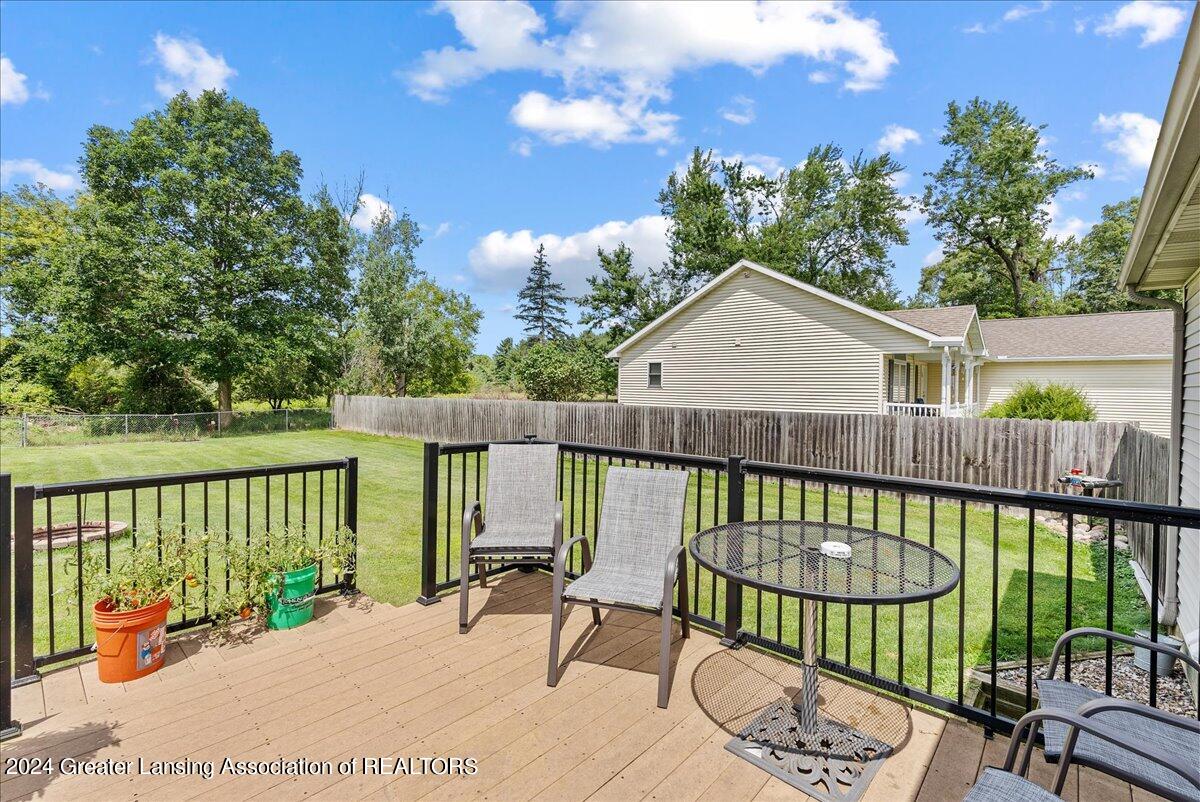 1645 North Aurelius Road Holt, MI 48842 - Photo 23 of 33 Back deck with newer boards and railing