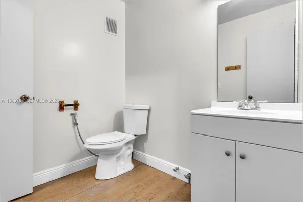 a bathroom with a sink toilet and a mirror