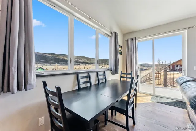 a dining room with furniture and wooden floor