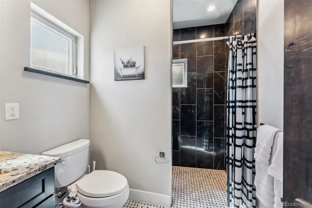 a bathroom with a toilet and shower