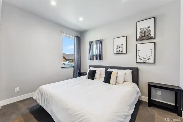 a bedroom with a bed and a painting