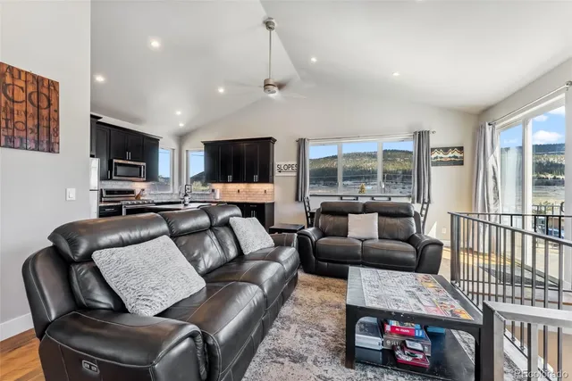 a living room with furniture a flat screen tv and a couch