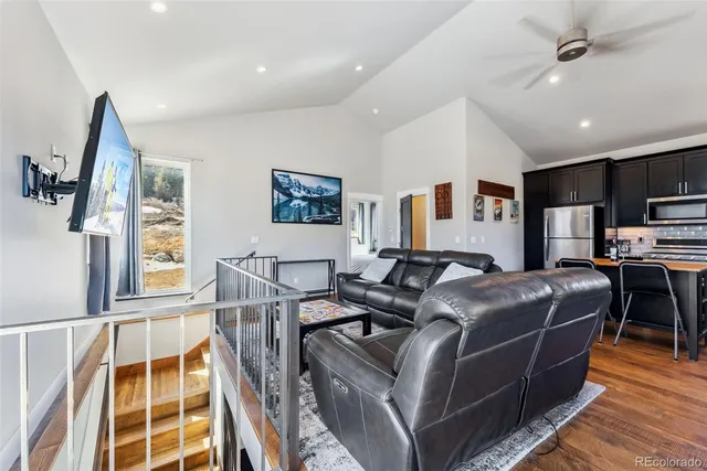 a living room with furniture a flat screen tv and a table