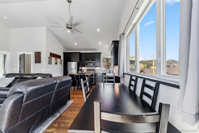 a living room with furniture a flat screen tv and a large window