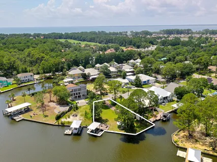 an aerial view of a houses with a swimming pool