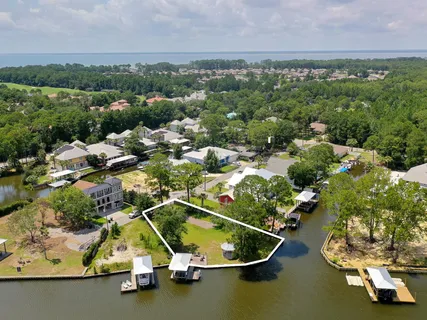 an aerial view of a house with a yard and lake view