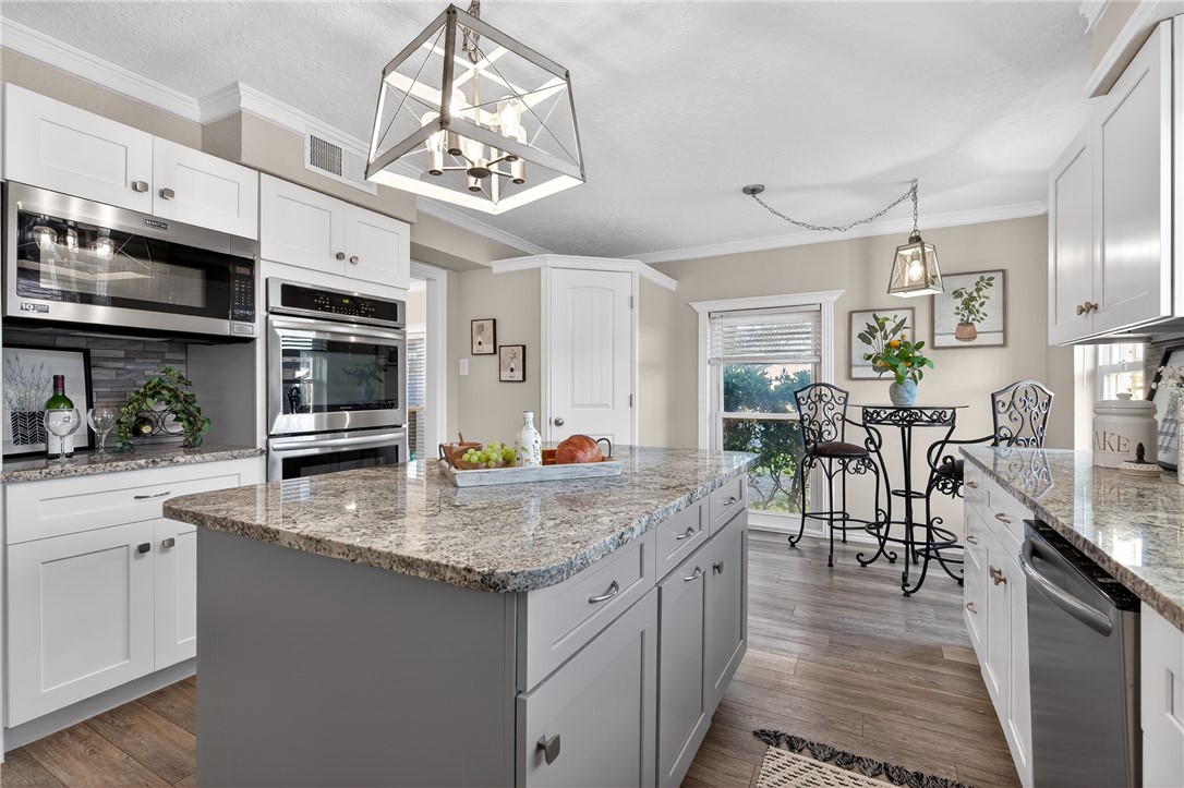 103 Granby Place Portland, TX 78374 - Photo 13 of 40 a kitchen with stainless steel appliances granite countertop a stove oven and a white cabinets