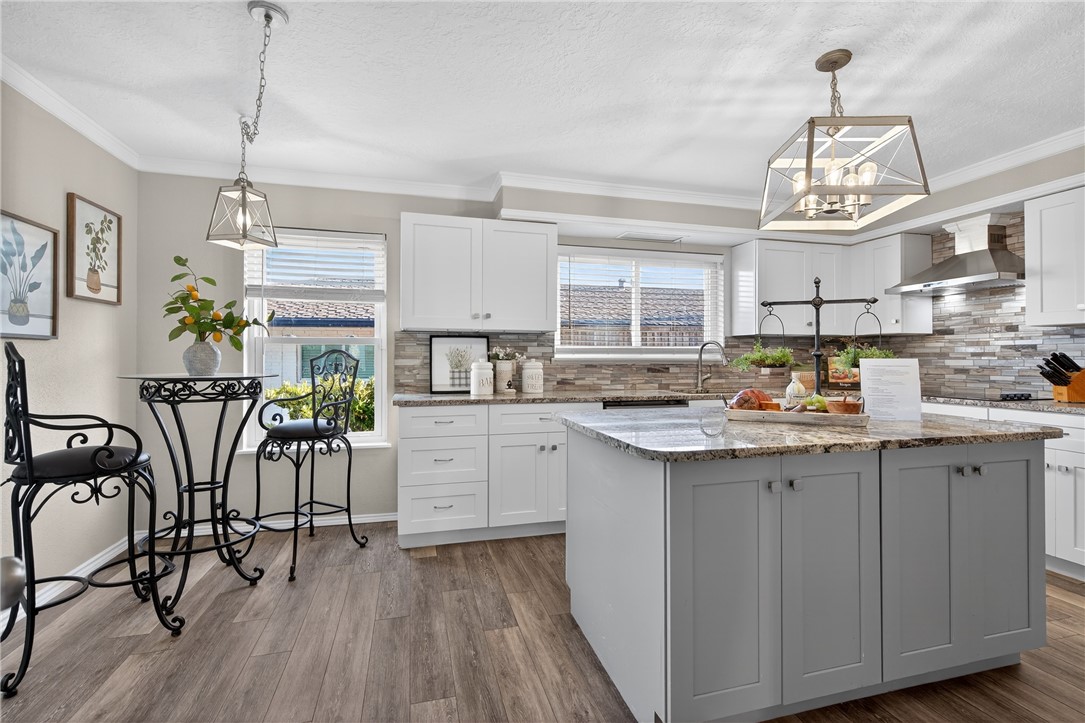 103 Granby Place Portland, TX 78374 - Photo 14 of 40 a kitchen with stainless steel appliances granite countertop a table chairs refrigerator and cabinets