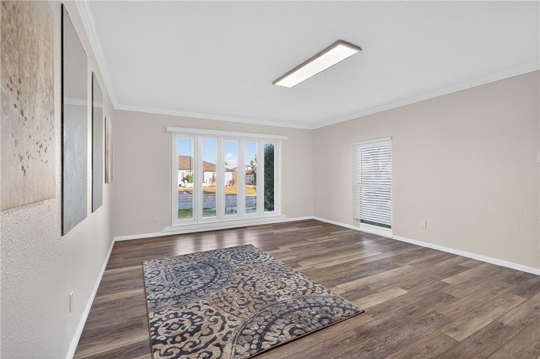 103 Granby Place Portland, TX 78374 - Photo 19 of 40 a view of an empty room with wooden floor and a window