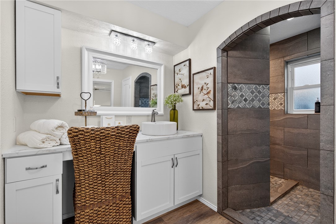 103 Granby Place Portland, TX 78374 - Photo 23 of 40 a bathroom with a sink a mirror and shower