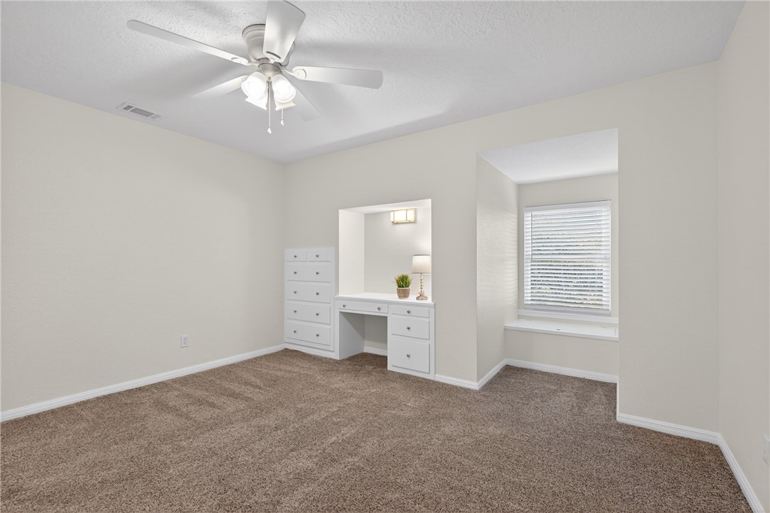 103 Granby Place Portland, TX 78374 - Photo 30 of 40 an empty room with chandelier fan and windows