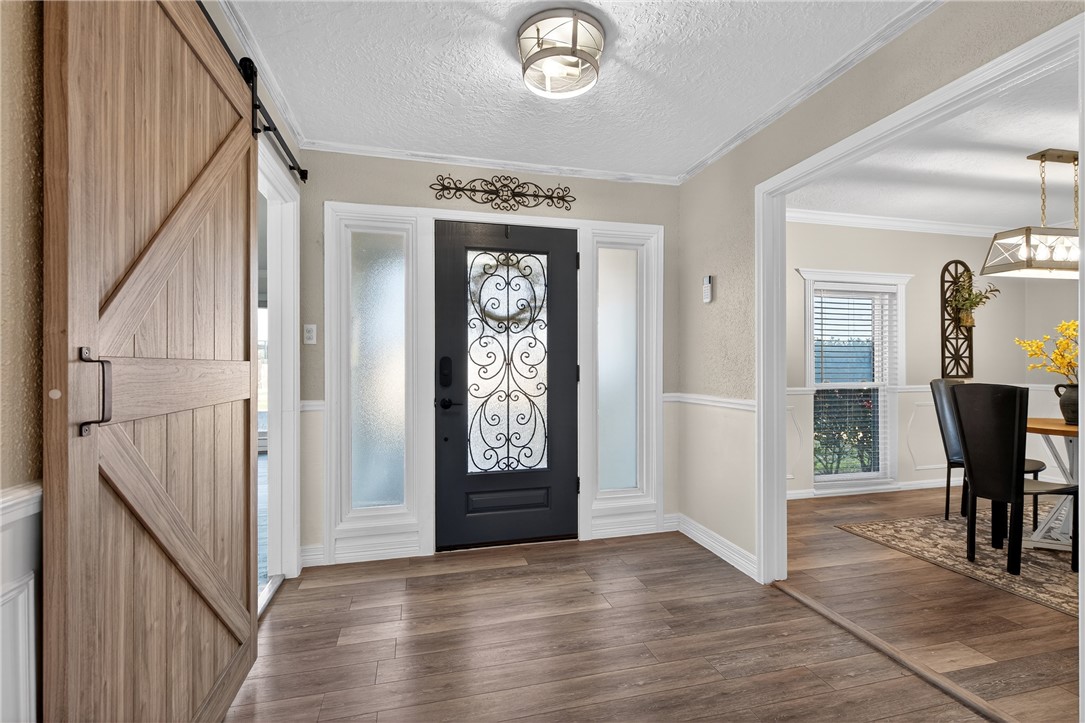 103 Granby Place Portland, TX 78374 - Photo 5 of 40 a view of a hallway with wooden floor and windows