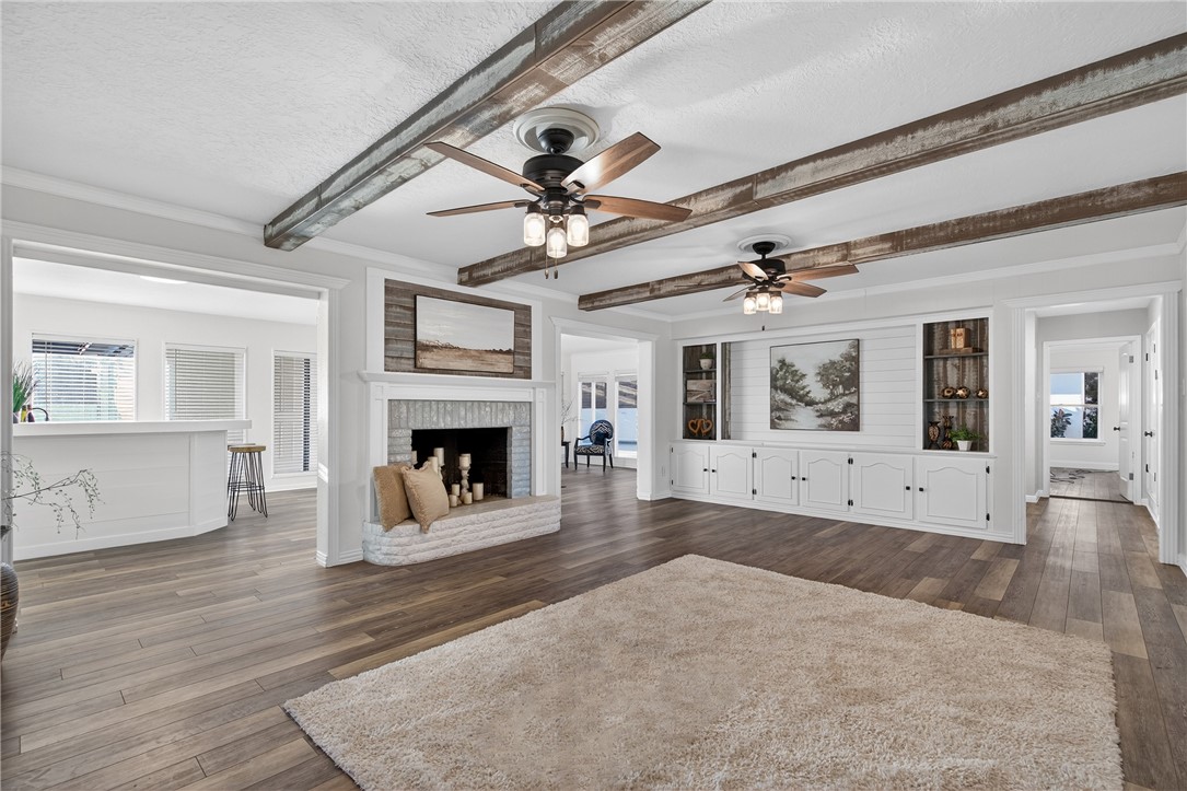 103 Granby Place Portland, TX 78374 - Photo 8 of 40 a view of an empty room with wooden floor and a fireplace