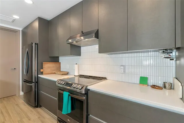 a kitchen that has a sink and a stove