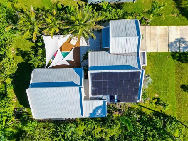 an aerial view of residential house with outdoor space and swimming pool