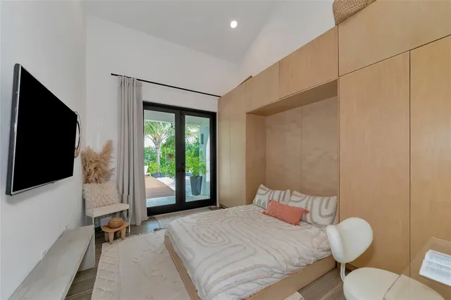 a bedroom with a bed and a flat screen tv