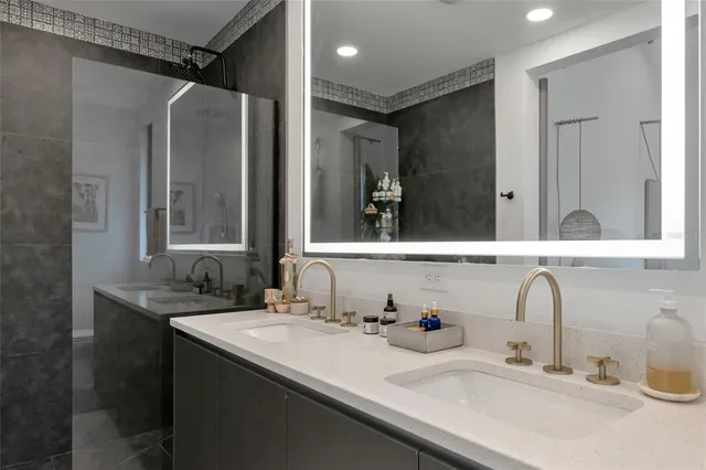 a bathroom with a double vanity sink and a mirror