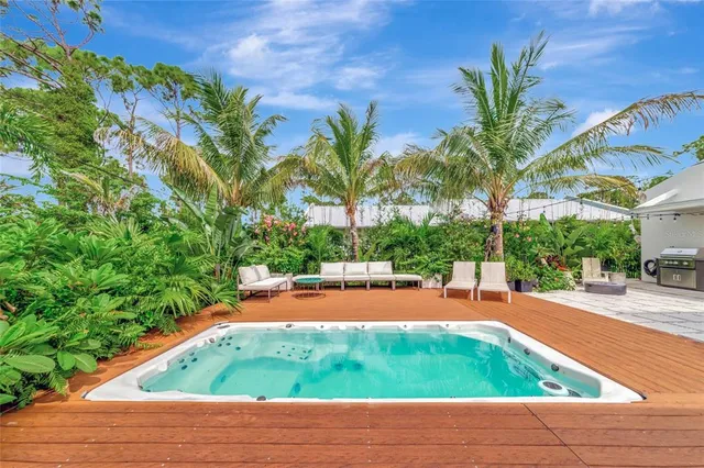 a wooden bench sitting in a yard with lawn chairs