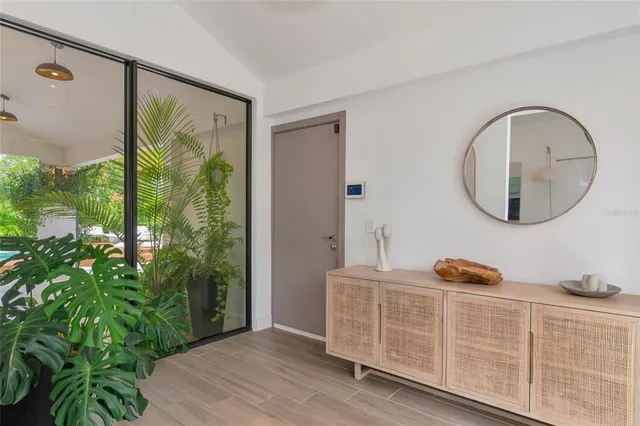 a view of a livingroom with wooden floor and a potted plant