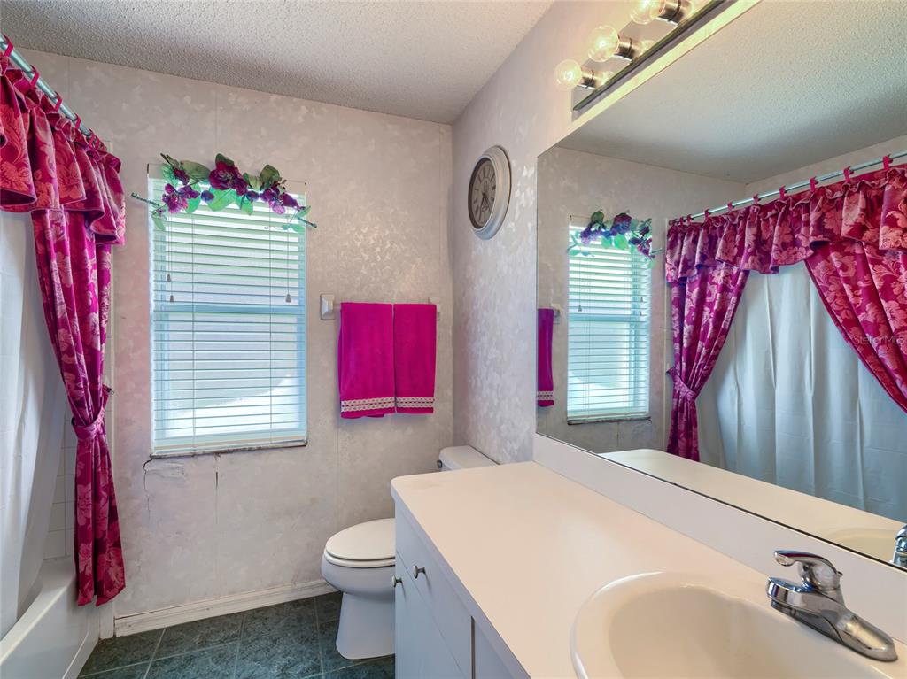 11228 Windrush Circle Hudson, FL 34667 - Photo 11 of 67 a bathroom with a sink toilet and a shower