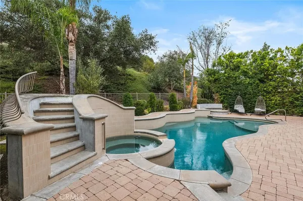 a view of a swimming pool with a patio