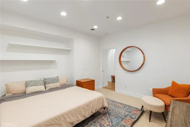 a bedroom with bed and a chair