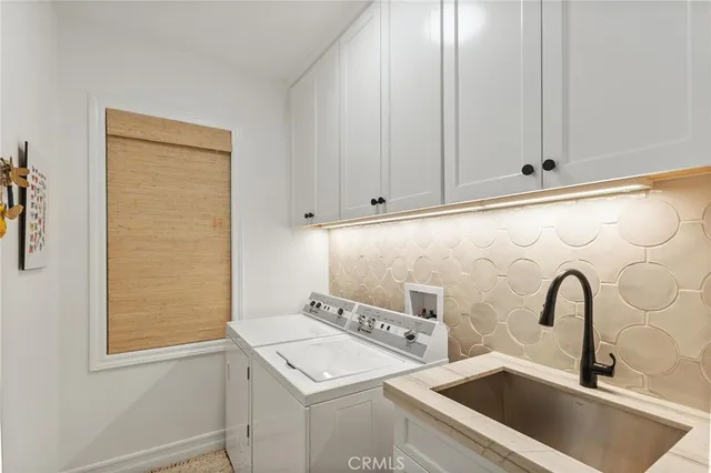 a view of staircase with lots of frames on wall and a rug