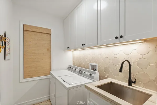 a view of staircase with lots of frames on wall and a rug