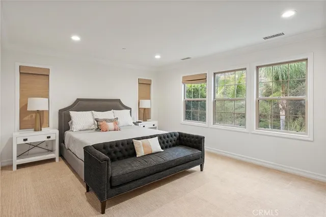 a bedroom with furniture and a flat screen tv